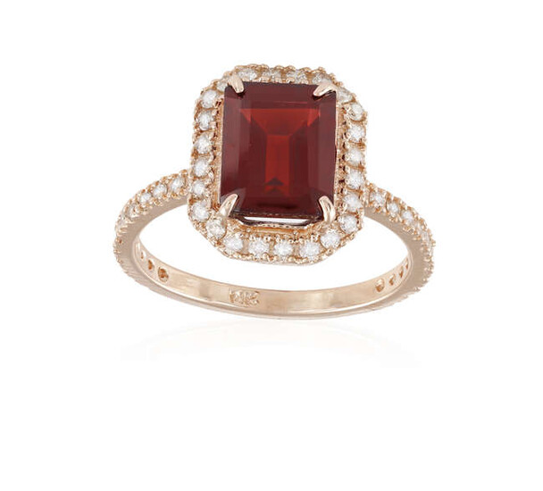 A GARNET AND DIAMOND DRESS RING, the central...