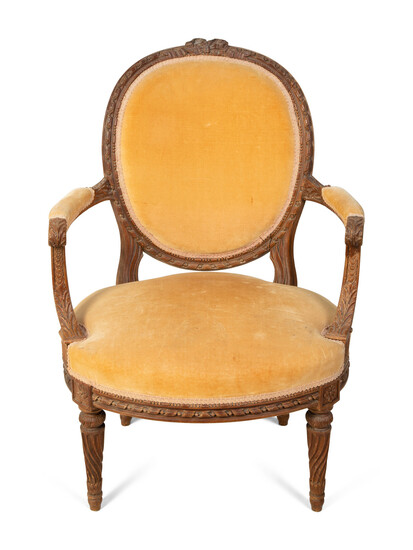 A Louis XVI Style Carved Fruitwood Fauteuil
