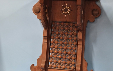 A PAIR OF ISLAMIC MAHOGANY WALL BRACKETS, THE STAR SHAPED SHELVES ABOVE BRACKETS INLAID WITH