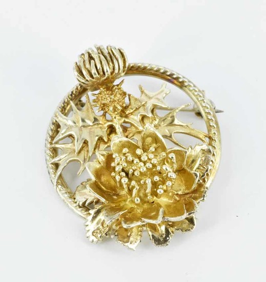 A STERLING SILVER AND GILT BROOCH