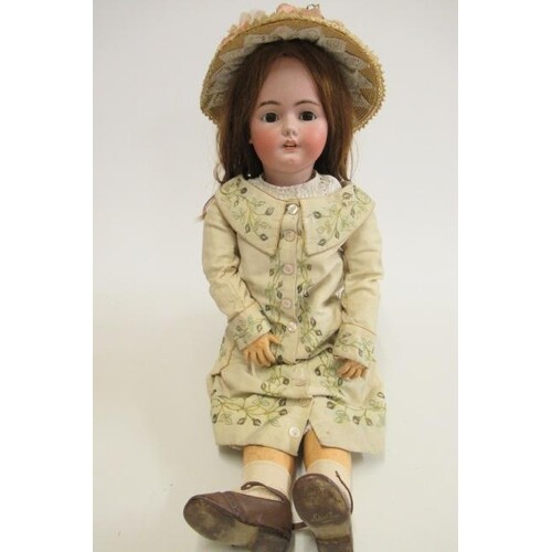 A Simon & Halbig bisque socket head doll, with brown glass s...