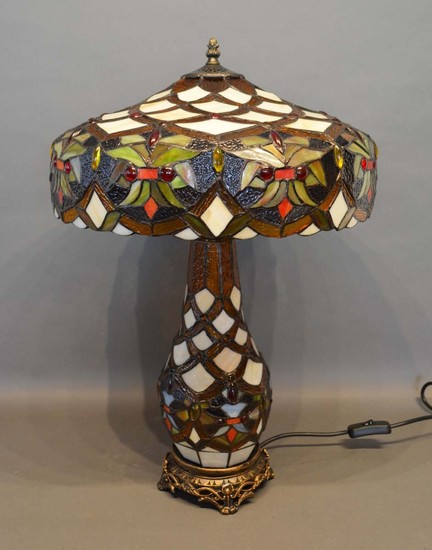 A Tiffany Style Glass and Metal Mounted Table Lamp with shad...
