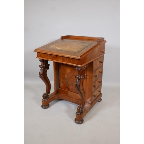 A Victorian figured walnut davenport with carved piano legs,...