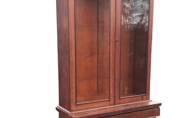 A Victorian mahogany bookcase, with two arched panelled doors enclosing...