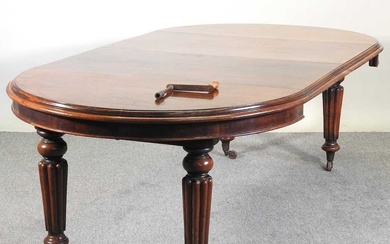 A Victorian mahogany oval wind out extending dining table, on...