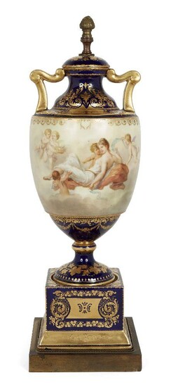 A Vienna porcelain urn-shaped lamp base, c.1900, painted to the body with Venus and nymphs on a richly gilded blue ground, with gilt-metal square base, blue marks to base, 52cm high