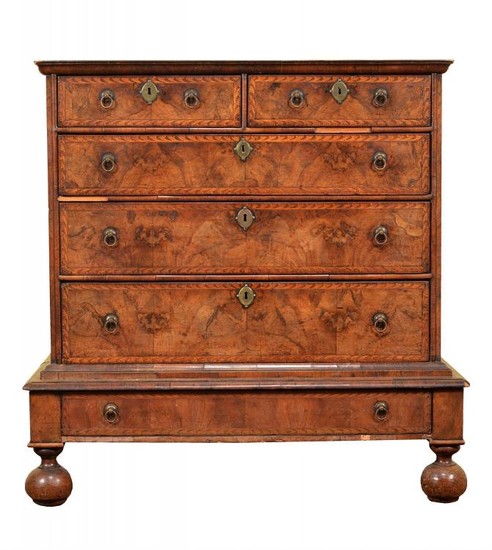 A William & Mary walnut and marquetry banded chest on stand