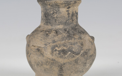 A Yortan culture earthenware tripodal vessel, the rounded body with lobed points and incised decorat