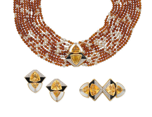A gem-set necklace, earring and brooch suite