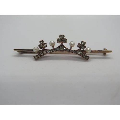 A gold diamond and pearl tiara shape brooch set with twenty-...