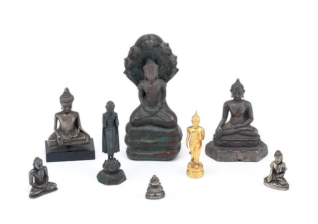 A group of eight various copper-alloy and yellow metal figures of Buddha