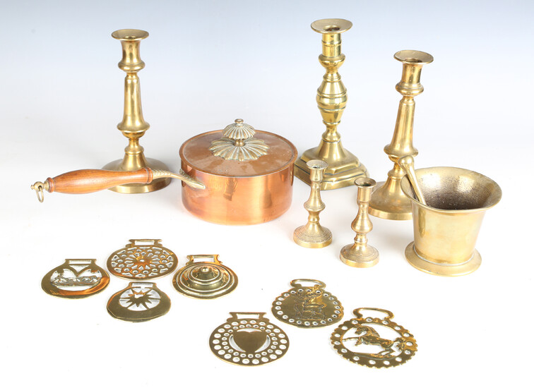 A group of metalware, including various horse brasses, three 19th century brass candlesticks, a copp