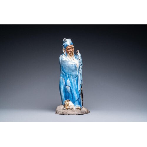 A large Chinese blue-glazed Shiwan pottery 'immortal' figure...