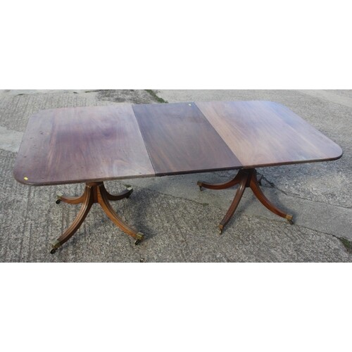 A mahogany double pedestal dining table with reeded edge and...