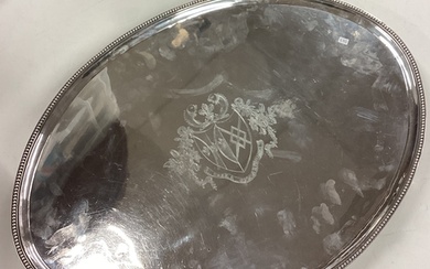 A massive oval George III silver tray attractively crested t...