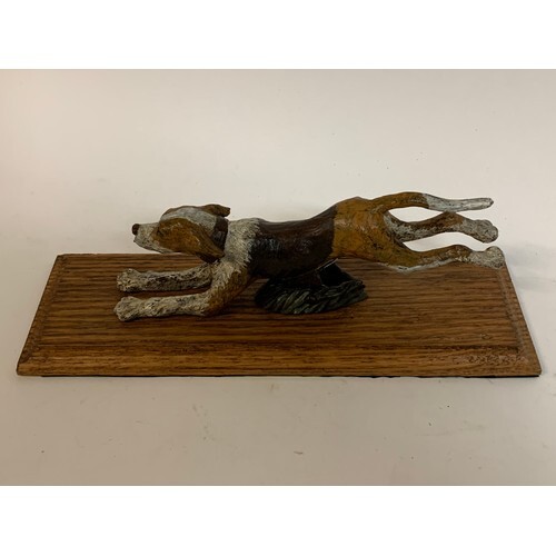 A painted bronze running hound dog paper clip, on an oak bas...
