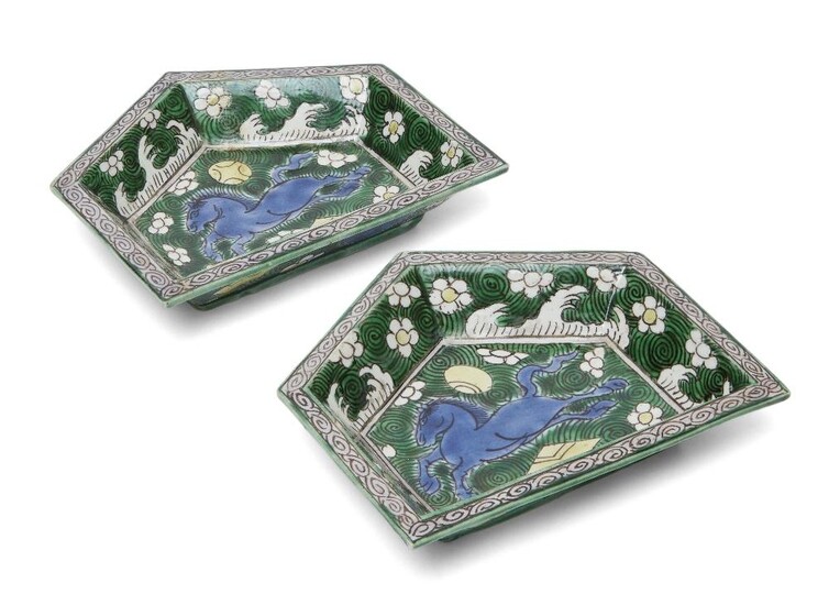 A pair of Chinese biscuit porcelain sancai sweetmeat dishes, Kangxi period, each of pentagonal form, painted to the centre with a horse in blue on a green turbine ground, the sides decorated with prunus and sea waves, 12cm long. (2) Provenance:...