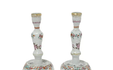 A pair of Chinese moulded famille rose and grisaille-enamelled octagonal candle sticks...