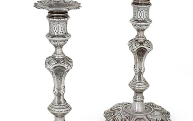 A pair of George II cast silver candlesticks, London 1745, James Gould, the knopped stems raised on shaped foliate scroll bases, the removable sconces with shaped foliate scroll rims, 22.1cm high, total weight approx. 43.3oz (pr) Provenance: The...