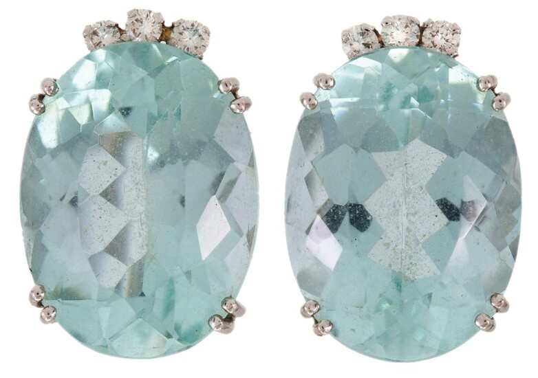 A pair of aquamarine and diamond earrings, each claw set with an oval-shaped aquamarine, accented with brilliant-cut diamonds, clip fittings.