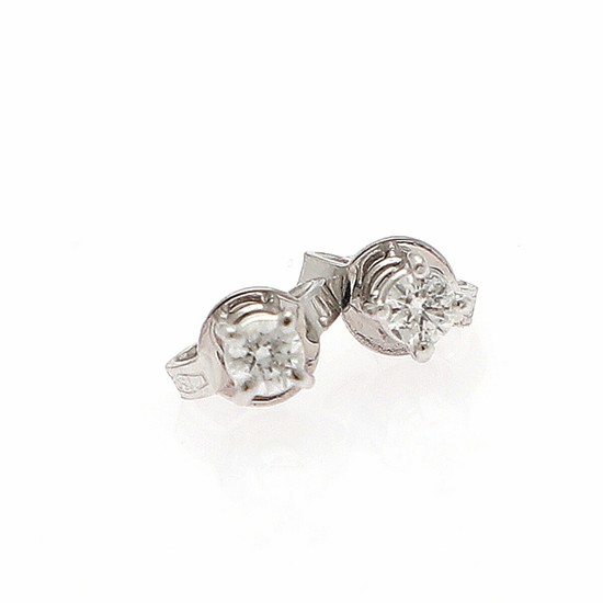 A pair of diamond solitaire ear studs each set with a brilliant-cut diamond totalling app. 0.49 ct., mounted in 18k white gold. L/SI. (2)