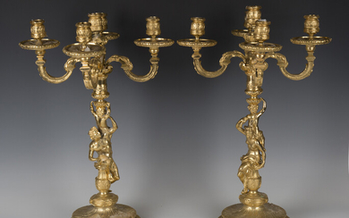 A pair of late 20th century cast gilt metal five-light candelabra with figural stems and circular ba