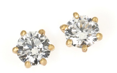 A pair of solitaire diamond ear studs each set with a brilliant-cut...