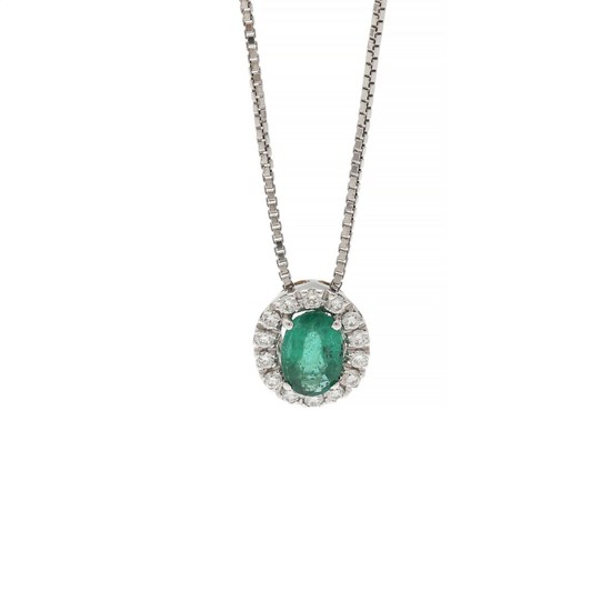 A pendant set with an oval-cut emerald weighing app. 0.57 ct. encircled by numerous diamonds, mounted in 18k white gold. Accompanied by chain of 18k white gold.