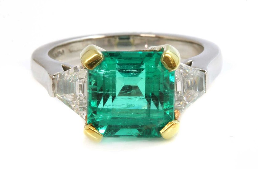 A platinum and gold Colombian emerald and diamond three stone ring