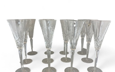 A set of nineteen Waterford Crystal cut glass champagne flut...