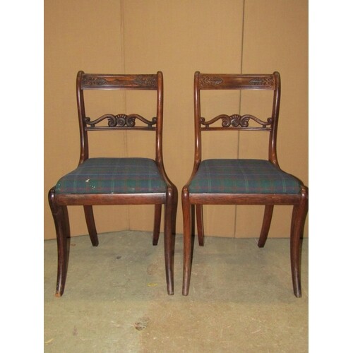 A set of seven Regency rosewood bar back dining chairs with ...