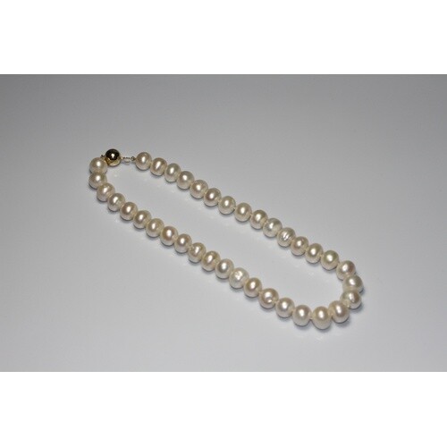 A string of white cultured pearls with a 9ct yellow gold bal...