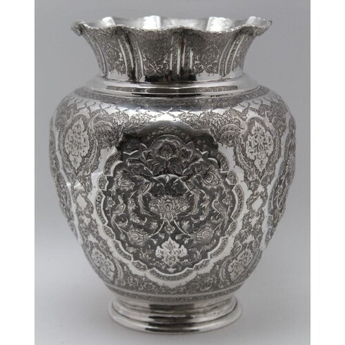AN EASTERN WHITE METAL VASE baluster form, repousse and chas...