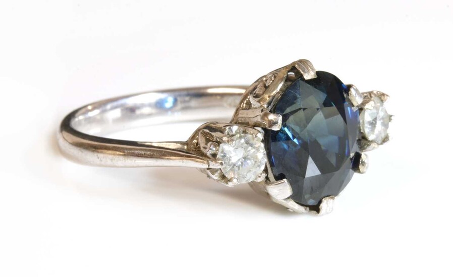 An 18ct white gold sapphire and diamond three stone ring