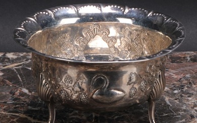 An Irish Provincial silver bowl, chased with a bird, a rabbi...