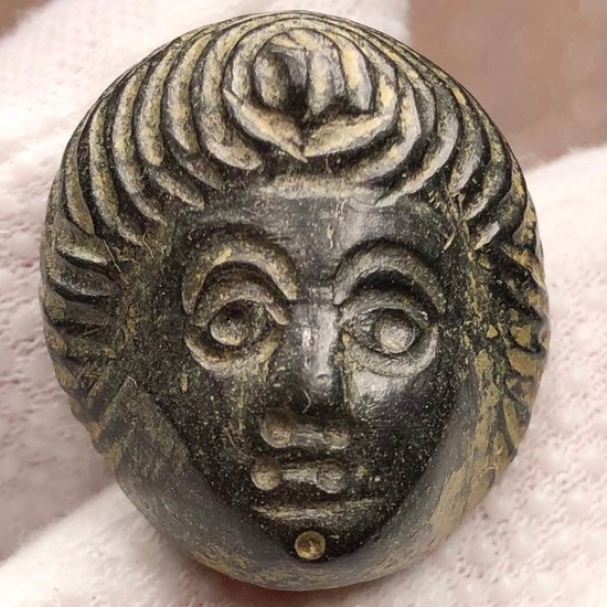 Ancient Roman Bronze Impressive Decorative Mask of Youth with an interesting Hairstyle.