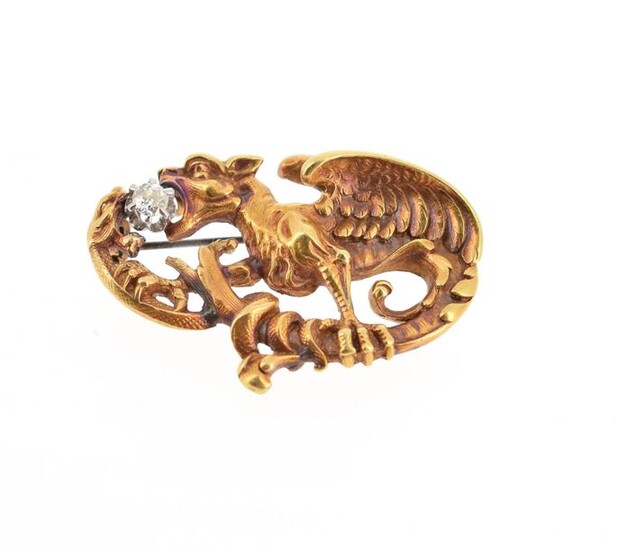 Brooch in 18 K (750 °/°°°) yellow gold representing a chimera fighting against a snake around an old cut diamond on either side of their gules; the pin brought back in silver plated metal Gross