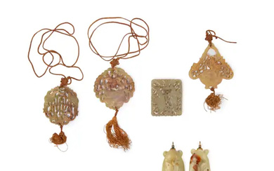 Five Chinese pierced celadon and russet jade pendants Late 19th/early 20th century...