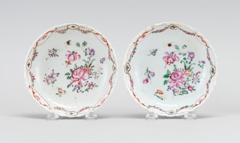 PAIR OF CHINESE FAMILLE ROSE PORCELAIN SAUCERS With slightly fluted exteriors, scalloped edges, floral sprays at center, and a swag...