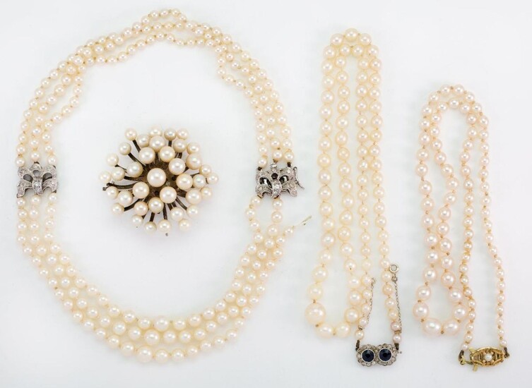 Three cultured pearl necklaces and a brooch, necklaces comprise: a graduated triple-row collar with single-cut diamond cluster bow shaped clasp and matching diamond cluster front panel, one row detached, length 33cm; a cultured pearl graduated...