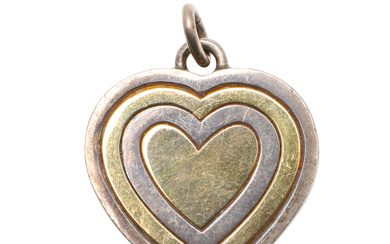 3298984. A 9CT GOLD AND SILVER HEART SHAPED PENDANT BY GUCCI.
