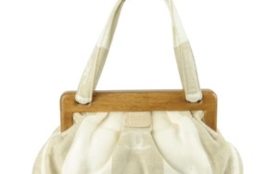 CHANEL - a white and beige canvas handbag. View more details