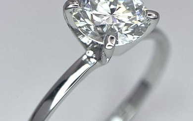 A 14 K white gold solitaire ring with a...