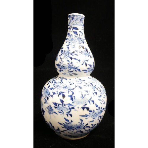 A 19TH CENTURY CHINESE BLUE AND WHITE PORCELAIN DOUBLE GOURD...