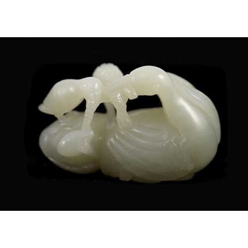 A Chinese pale celadon jade ducks and millet group the sto...