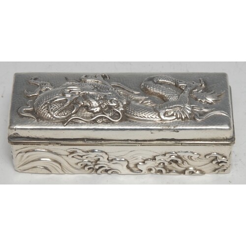 A Chinese silver rectangular box, in relief with a ferocious...