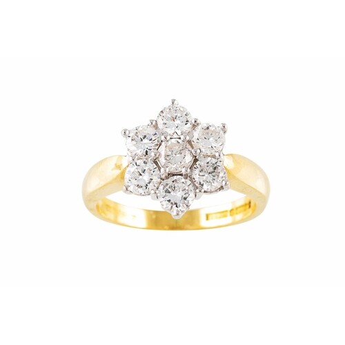 A DIAMOND SEVEN STONE DRESS CLUSTER RING, mounted in 18ct ye...