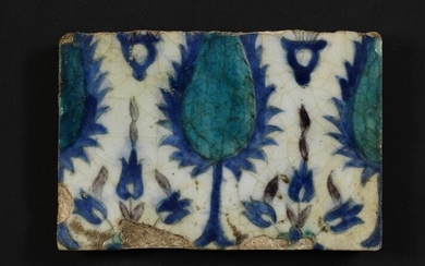 NOT SOLD. A Damascus pottery tile decorated in blue, turquoise and manganese with flowers. Syria, 18th century. 14 × 22 cm. – Bruun Rasmussen Auctioneers of Fine Art
