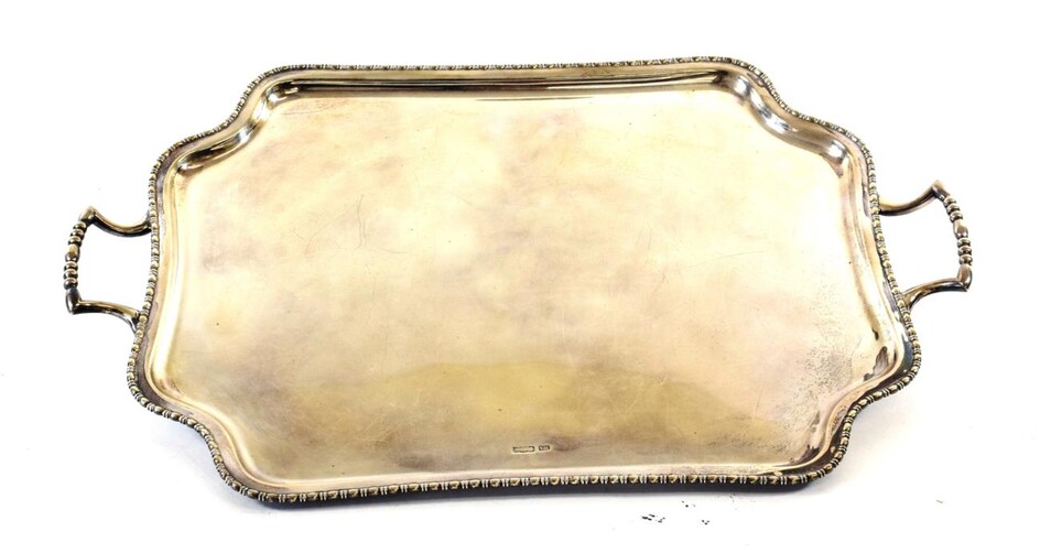 A George V Silver Tray, by Atkin Bros., Sheffield, 1910, shaped oblong and with beaded rim, on four