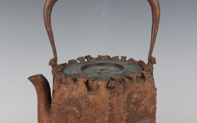 A Japanese cast iron tetsubin (tea kettle) by Ryubundo, early 20th century, the hexagonal body cast
